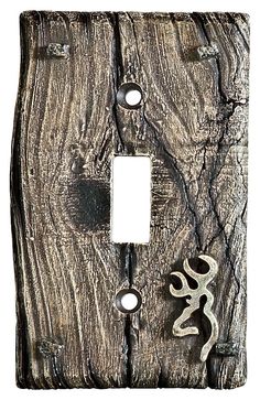 a light switch cover with an image of a snake on the wood grained surface