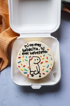 a decorated cookie in a white box on a table