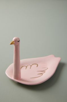 a pink plate with a bird on it