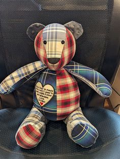 a plaid teddy bear sitting in an office chair