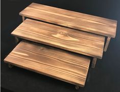 three wooden benches stacked on top of each other