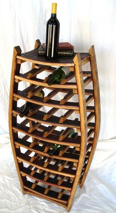 a wine rack made out of wood with bottles on top and two glasses in the bottom