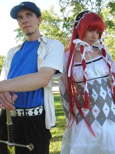 two people dressed in costumes standing next to each other