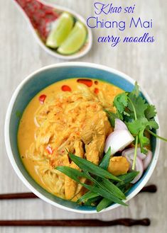 a bowl filled with curry and vegetables next to chopsticks