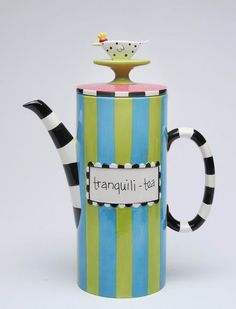 a ceramic tea pot with a lid and handle that says tranquili - tas