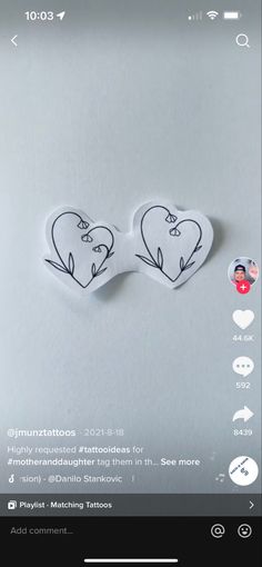 two heart shaped stickers on top of a white surface with the words love written in it