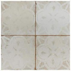 a white tile floor with four different designs on it