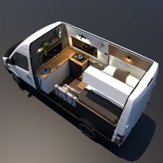 the interior of a small camper van with its bed and kitchenette in it