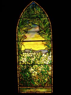 a stained glass window with white flowers in it