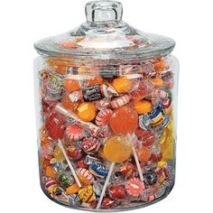 a large glass jar filled with lots of candies on top of a white background