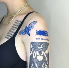 a woman with a tattoo on her arm has a blue dragon and a black cat