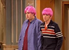 two men with pink hair standing next to each other