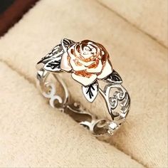 a rose ring sitting on top of a box