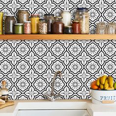 a kitchen counter topped with jars filled with fruit