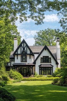 Modern Tudor house with lush greenery and blue sky. The charming fusion of history and contemporary flair in modern Tudor houses can transform your living space from “just nice” to “royalty-approved.” Tudor Living Room, House Blend, Stone Path