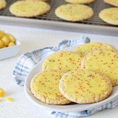 some cookies are sitting on a plate next to corn