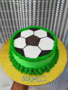 a soccer ball cake with green and white frosting