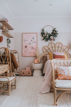 a bedroom with wicker furniture and pink decor on the walls, along with other items