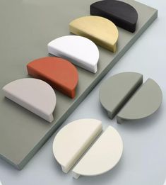 several different shapes and sizes of furniture on a gray surface with white, black, red, yellow, and grey colors