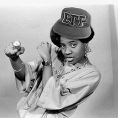 a black and white photo of a woman wearing a hat with the word ete on it