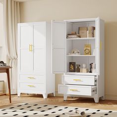 a white cabinet with yellow handles and drawers in a room next to a table, rug and chair