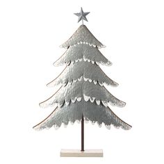 a metal christmas tree on a stand with a star on it's top and silver tinsel