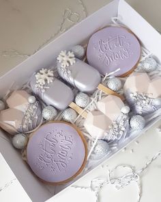 a box filled with lots of decorated cookies