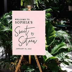 a welcome sign is displayed in front of some plants