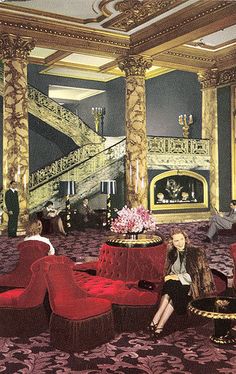 people sitting on red couches in an ornately decorated room with stairs and chandeliers