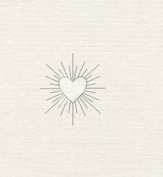 a heart drawn in the middle of a white paper with sun rays coming out of it