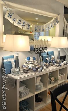 a dining room table is decorated with blue and silver decorations