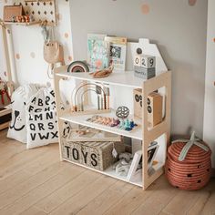 a child's playroom with toys, books and other items on the shelves