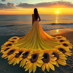 a woman is standing on the beach with sunflowers in front of her back