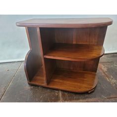 a wooden shelf sitting on top of a tiled floor