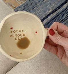 a person holding a coffee mug with the words today is your day written on it