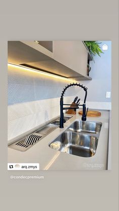 an image of a kitchen setting with stainless steel sink and faucet in the middle