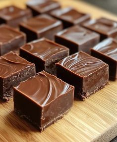 several pieces of chocolate sitting on top of a wooden cutting board