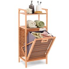 This our tilt-out bamboo laundry hamper with shelf ,this unique piece has a bamboo slatted frame with 2 storage shelves above the tilt-out hamper space. The hamper liner itself is a removable, the hamper liner lifts out of the hamper for easy handling and clean with a damp cloth. Two open shelves provide ample space, you can place one in the bathroom, and keep fresh towels stacked on top. Color: Natural. Laundry Hamper Cabinet, Tilt Out Laundry Hamper, Laundry Organizers, Laundry Shelves, Laundry Basket Organization, Bamboo Shelf, Bamboo Bathroom, Laundry Room Shelves, Bathroom Storage Shelves