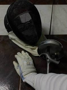 a gloved hand is next to a heater on a table with a hat and gloves