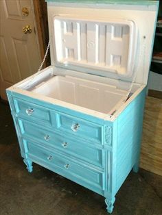 an ice chest is painted blue and has chains hanging from the top to hold it