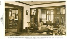 an old black and white photo of a living room with wood trimming on the walls