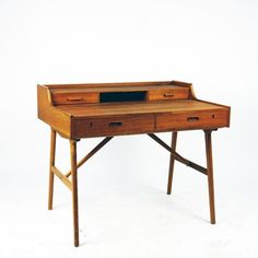 an old wooden desk with two drawers and a shelf on the top, against a white background