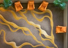 an overhead view of a living room with orange chairs