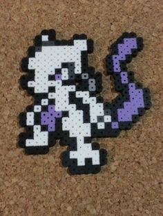 the pixel art is made out of black and white beads, with purple dots on it