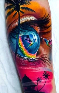 an eye with a rainbow colored background and palm trees on the side of his arm