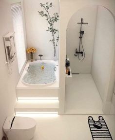 a bathroom with a toilet, sink and bathtub in the middle of the room