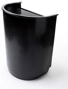 a black trash can sitting on top of a white floor