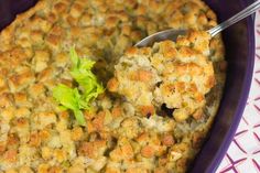 a casserole dish filled with stuffing and garnished with lettuce