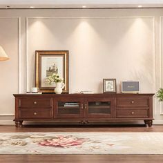 a living room scene with focus on the entertainment center and rug in the foreground