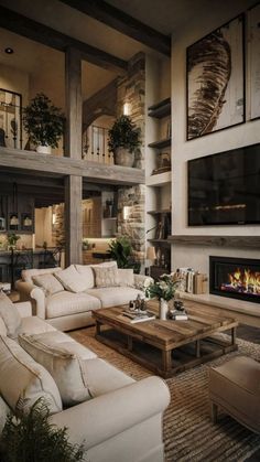 a living room filled with furniture and a flat screen tv mounted to the wall over a fire place